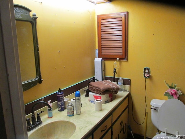 bathroom featuring vanity and toilet