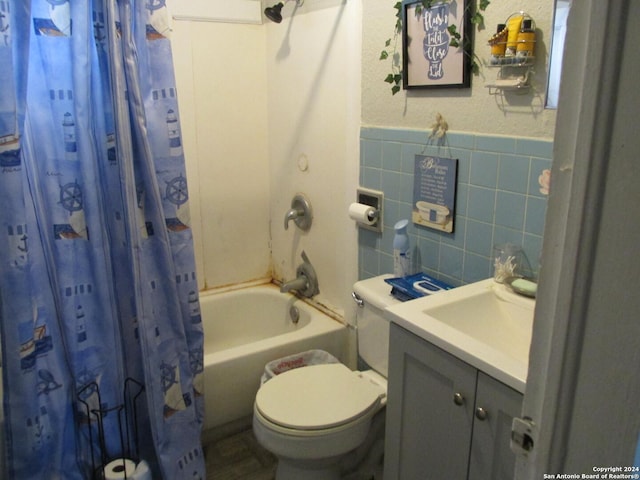 full bathroom featuring vanity, toilet, tile walls, and shower / tub combo with curtain