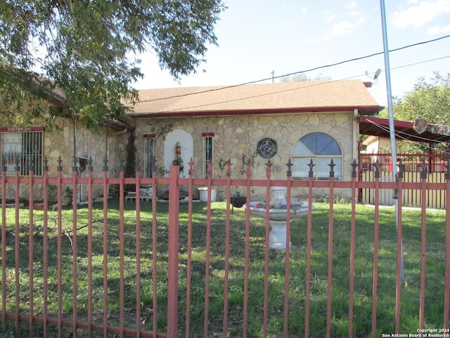 view of gate featuring a yard