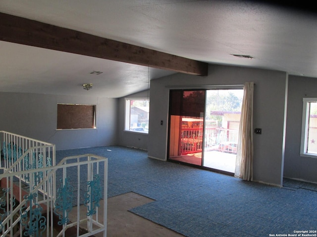 bonus room with carpet floors, lofted ceiling with beams, and a textured ceiling