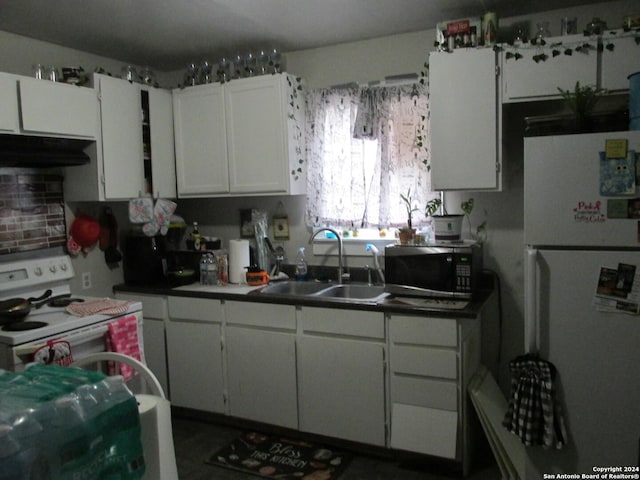 kitchen featuring tasteful backsplash, white cabinetry, sink, and white appliances