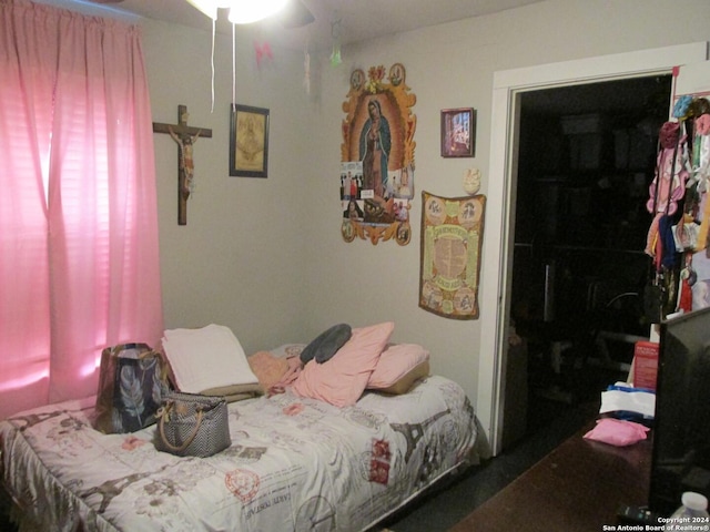 bedroom with ceiling fan and a closet