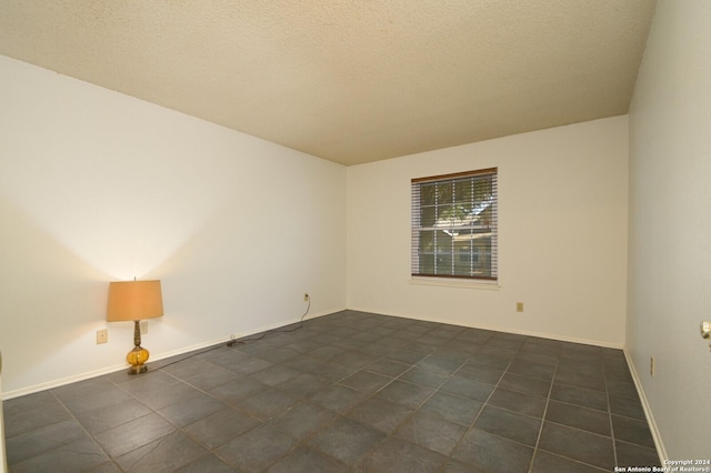 empty room featuring a textured ceiling