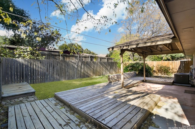 deck featuring central air condition unit and a yard