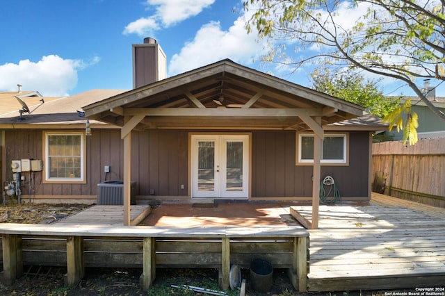 back of property featuring cooling unit, a wooden deck, and french doors