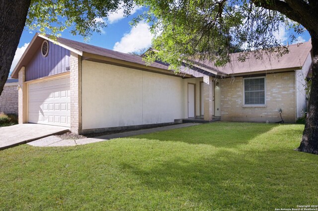 view of side of property with a lawn and a garage