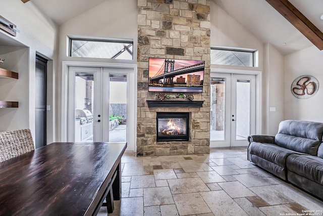 living room with plenty of natural light, beam ceiling, and french doors