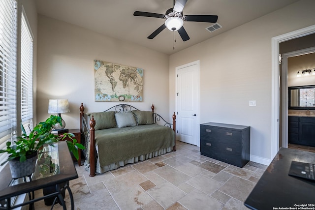 bedroom featuring ceiling fan and ensuite bath