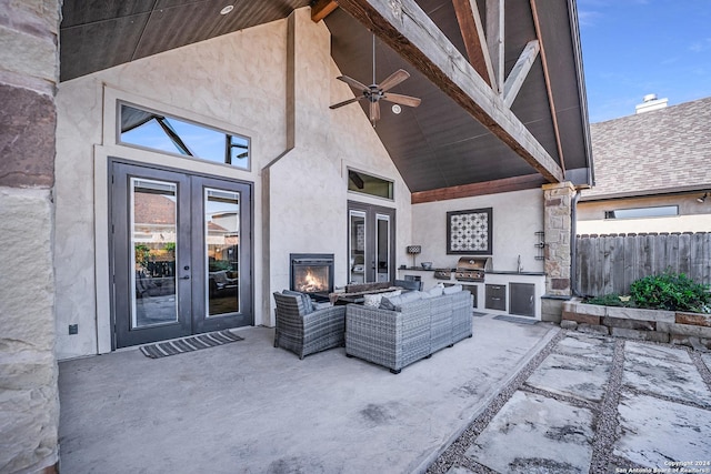 view of patio / terrace featuring ceiling fan, french doors, sink, an outdoor kitchen, and a grill