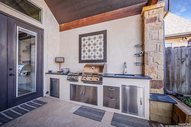 view of patio / terrace with grilling area, sink, and an outdoor kitchen