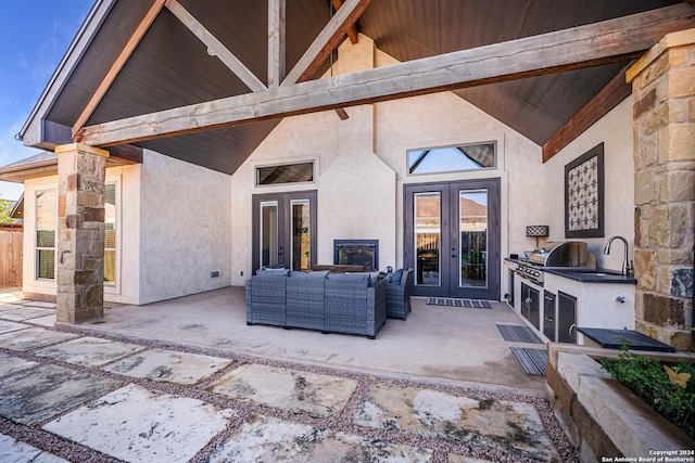 view of patio featuring area for grilling, outdoor lounge area, french doors, and sink