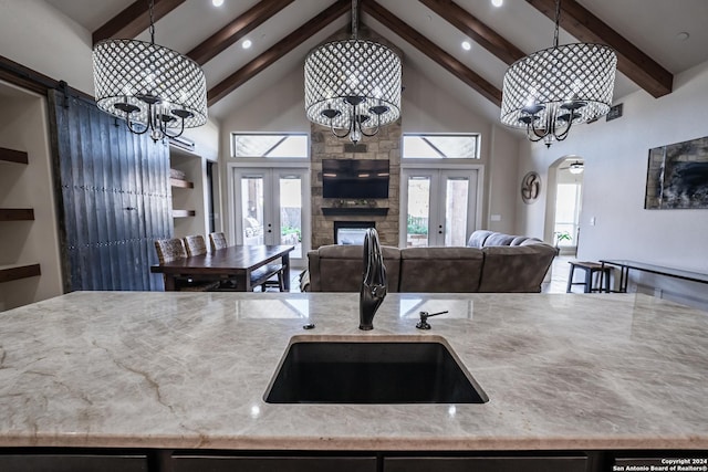 kitchen with french doors, high vaulted ceiling, and pendant lighting