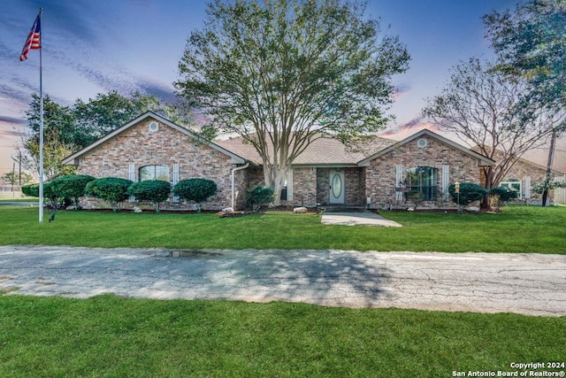 ranch-style house featuring a lawn