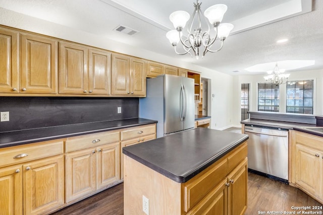 kitchen featuring stainless steel appliances, dark hardwood / wood-style floors, a notable chandelier, decorative light fixtures, and a kitchen island