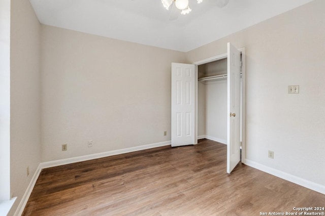 unfurnished bedroom with hardwood / wood-style floors and a closet