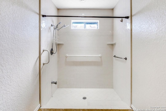 bathroom with tiled shower