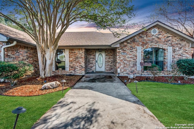 ranch-style house with a lawn