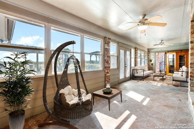 sunroom / solarium with french doors and ceiling fan