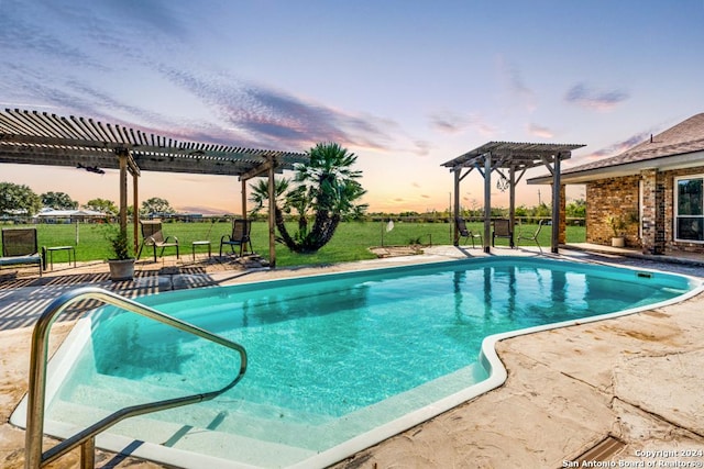 pool at dusk featuring a pergola, a patio, and a lawn