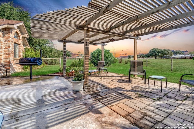 patio terrace at dusk with a lawn and a pergola