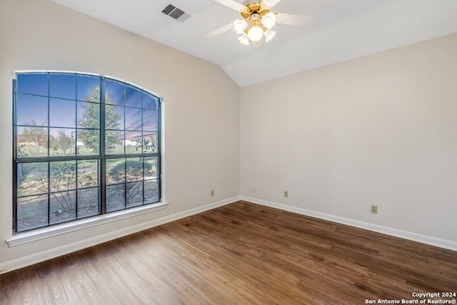 unfurnished room with ceiling fan, dark hardwood / wood-style flooring, and vaulted ceiling