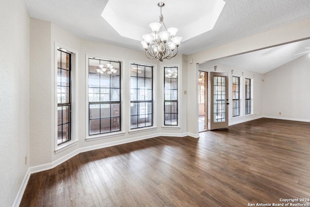 interior space with a wealth of natural light, dark hardwood / wood-style flooring, and a textured ceiling