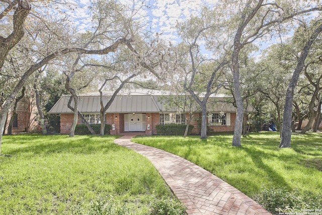 ranch-style home with a front lawn