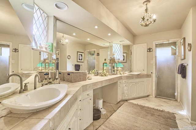 bathroom with tile patterned flooring, vanity, and a chandelier