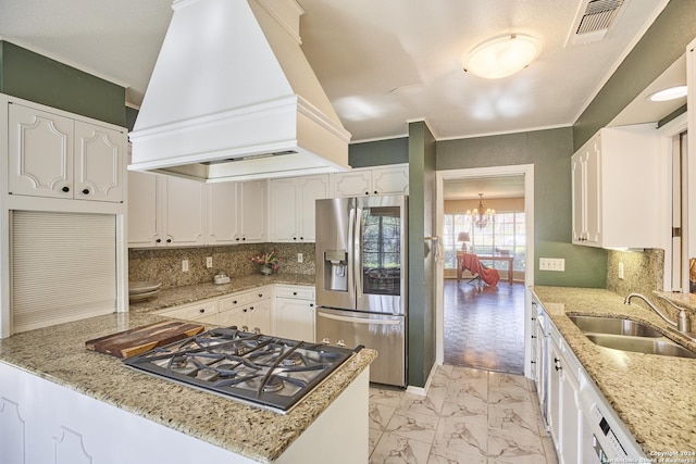 kitchen featuring light stone counters, sink, stainless steel appliances, and custom range hood