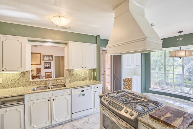 kitchen featuring sink, stainless steel range oven, premium range hood, white dishwasher, and white cabinets