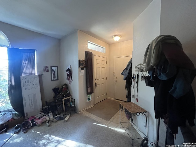 foyer entrance with light colored carpet