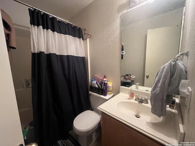 full bathroom featuring vanity, shower / bath combination with curtain, and toilet