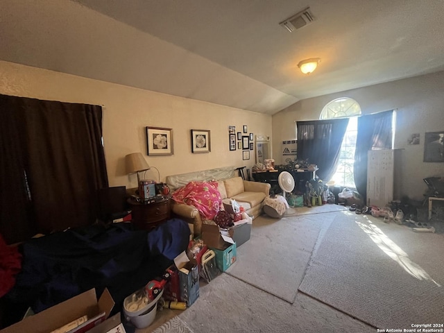 carpeted bedroom with lofted ceiling