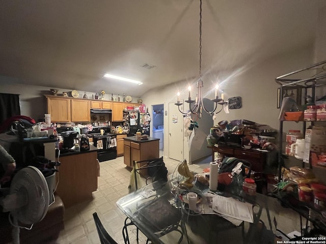 dining space featuring washer / dryer, lofted ceiling, and an inviting chandelier