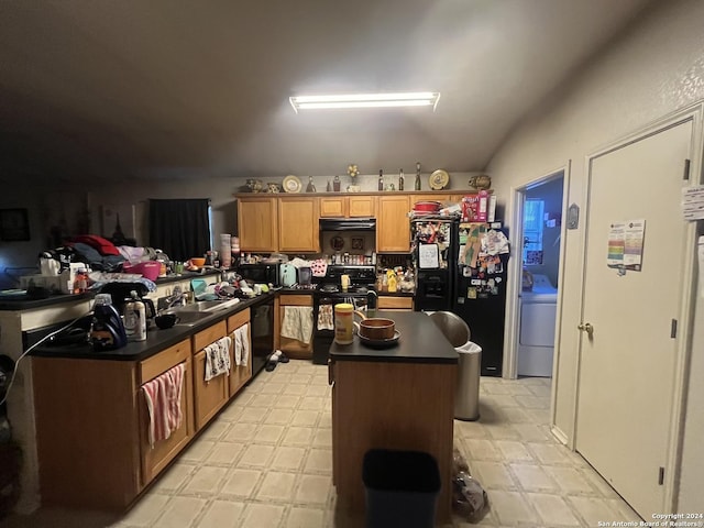 kitchen featuring a center island, exhaust hood, black appliances, vaulted ceiling, and washer / clothes dryer