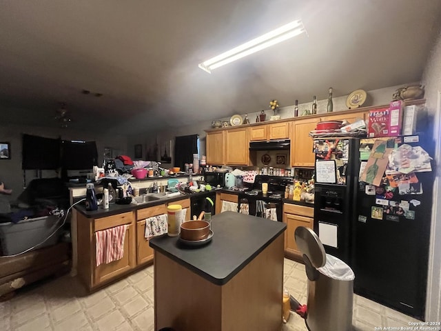 kitchen featuring kitchen peninsula, sink, a center island, and black appliances