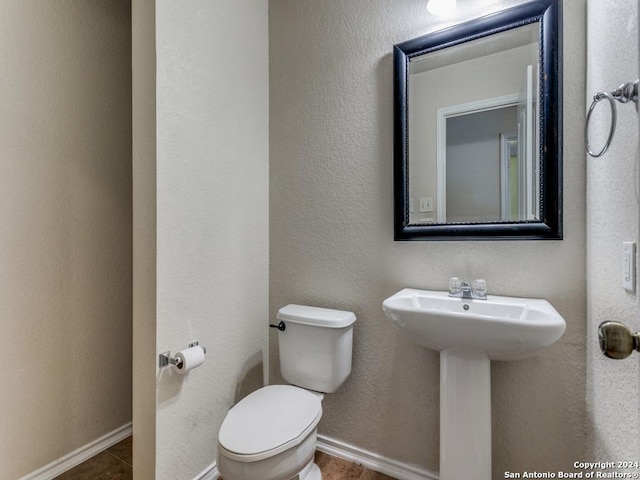 bathroom with sink, tile patterned flooring, and toilet