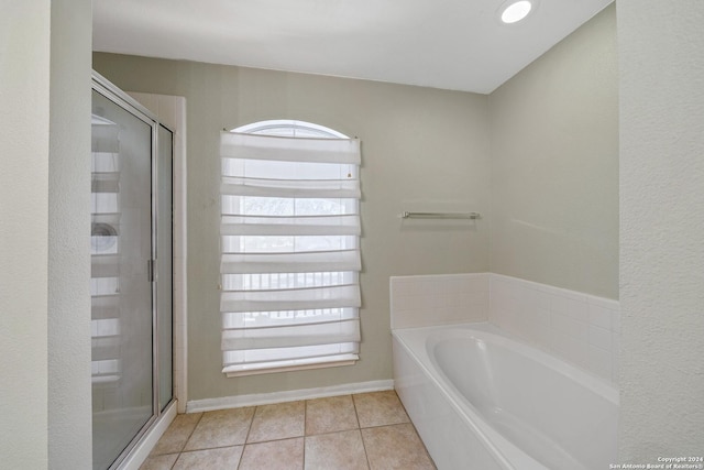 bathroom featuring tile patterned flooring and separate shower and tub