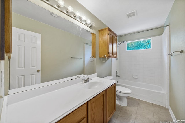 full bathroom with tile patterned floors, toilet, vanity, and tiled shower / bath