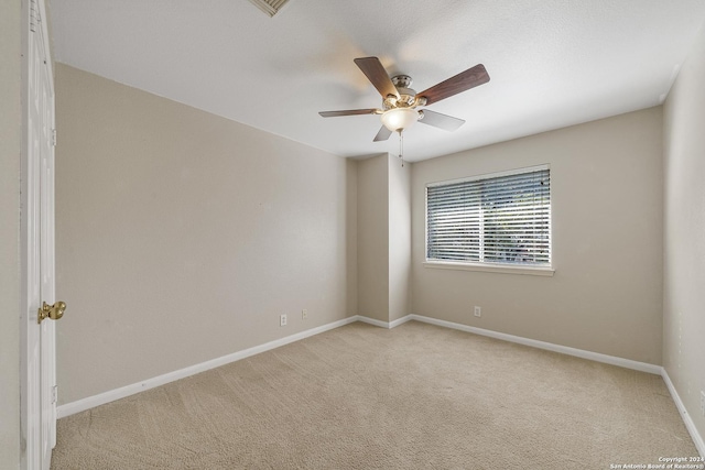 unfurnished room featuring ceiling fan and light carpet