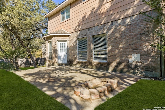 exterior space with a lawn and a patio