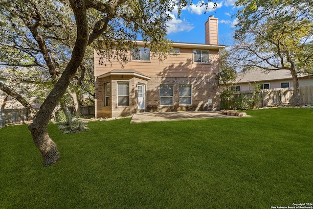 rear view of property with a patio area and a yard