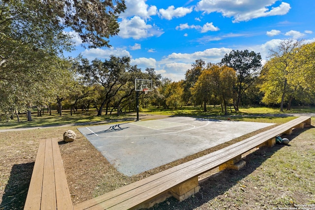 view of sport court featuring a lawn