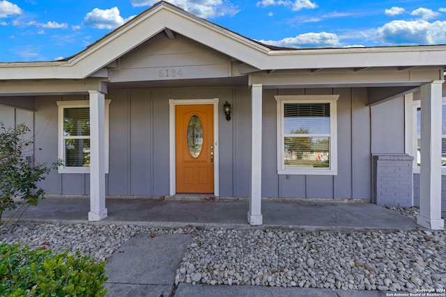 view of exterior entry with a porch