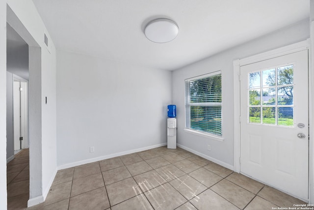 spare room featuring light tile patterned floors