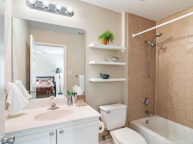 full bathroom with vanity, toilet, and tiled shower / bath combo