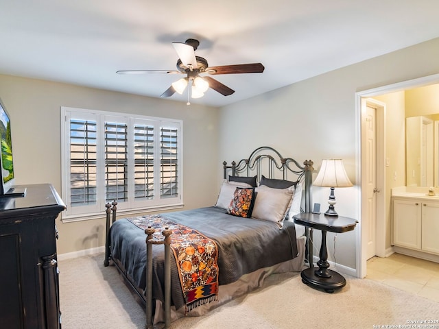 carpeted bedroom with ceiling fan and ensuite bathroom