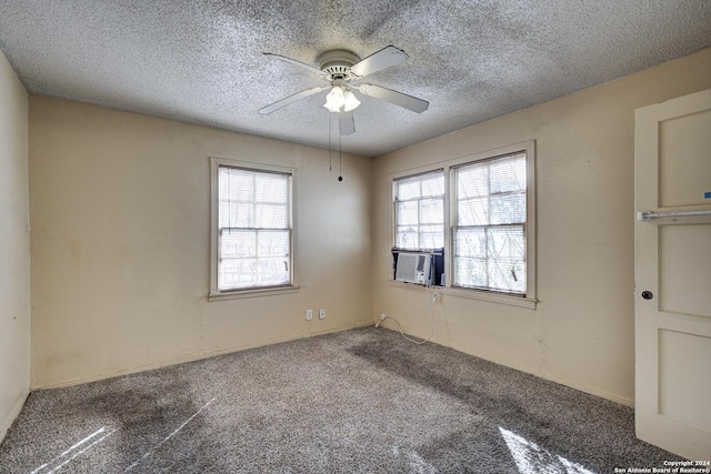 empty room featuring a textured ceiling, carpet floors, ceiling fan, and cooling unit