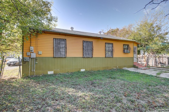 view of side of home featuring a yard