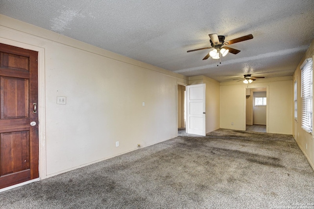 empty room featuring carpet and a textured ceiling